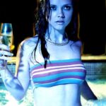 Christina Ricci hot in a tight striped sports bra hanging out in a hot tub drinking some champagne.